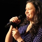 AT Out by 10, Leslie Goshko steps up to the mic with a smile.